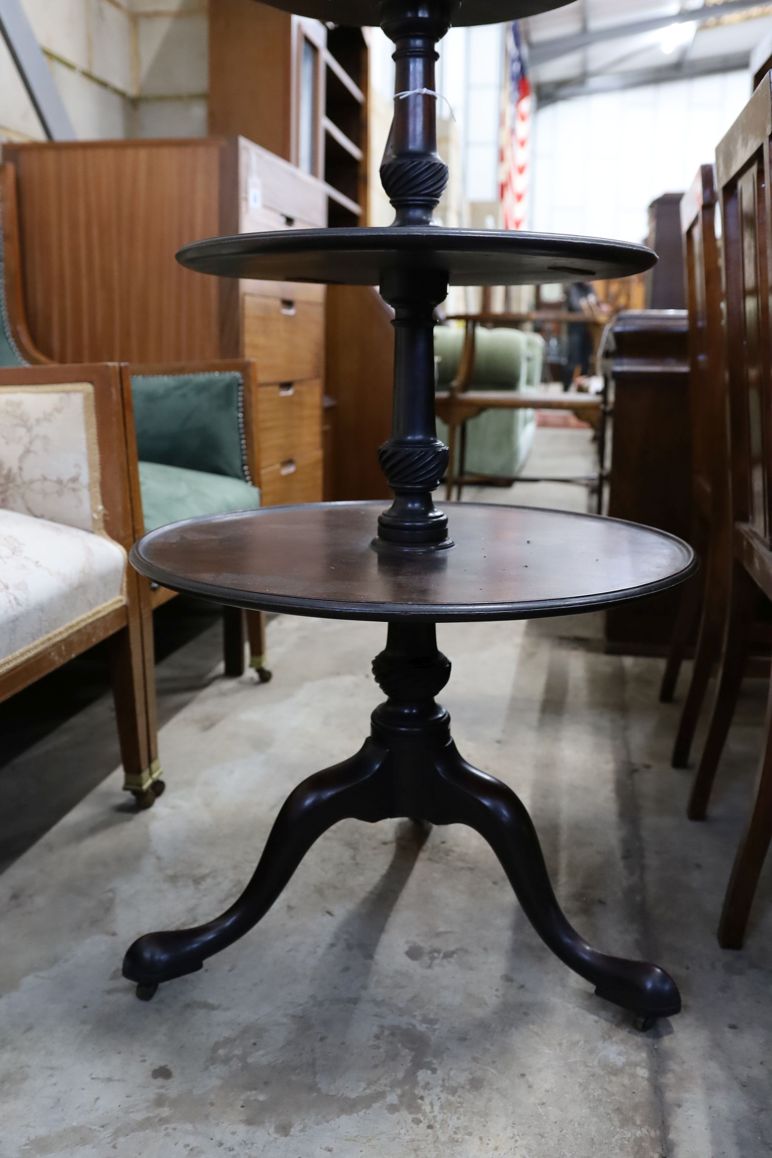 A George III circular mahogany three tier dumb waiter, diameter 60cm, height 106cm